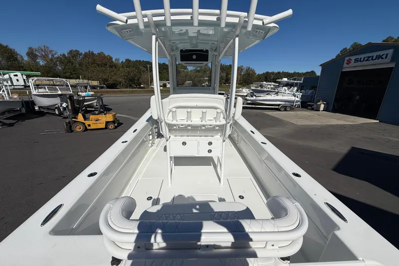 Slide: The Image of 2025 Pair Customs 28 Center Console boat at a Suzuki dealership, showcasing sleek design. - 14