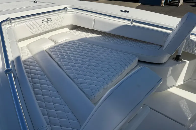 Slide: The Image of Luxurious seating on 2025 Pair Customs 28 Center Console boat with diamond-stitched upholstery. - 17