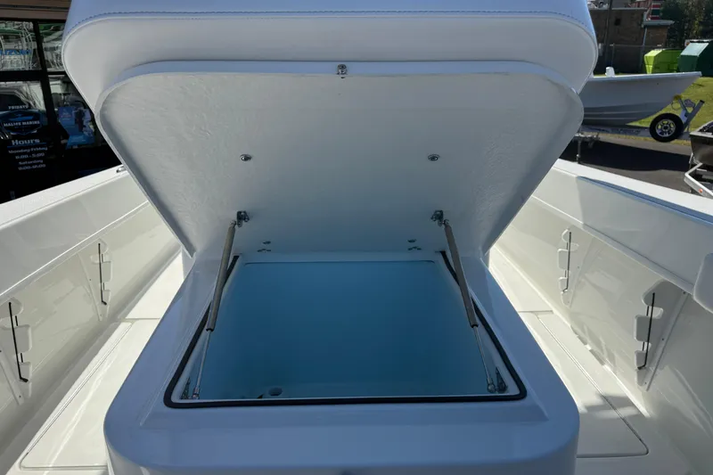 Slide: The Image of 2025 Pair Customs 28 Center Console boat with open storage compartment. - 19