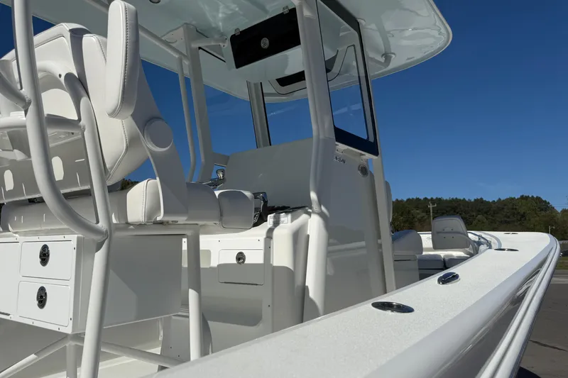 Slide: The Image of 2025 Pair Customs 28 Center Console boat, sleek white design, spacious seating, clear blue sky. - 20