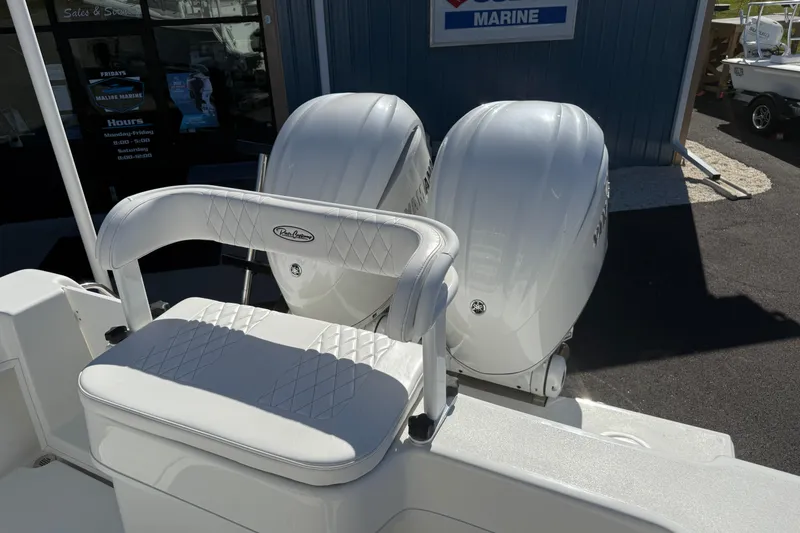 Slide: The Image of 2025 Pair Customs 28 Center Console boat with dual engines and cushioned seating. - 7
