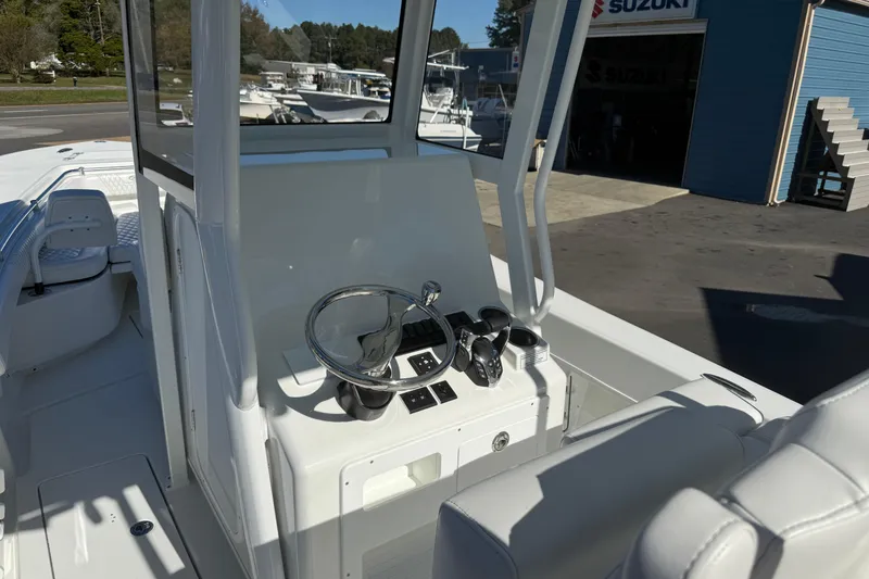 Slide: The Image of 2025 Pair Customs 28 Center Console boat interior with steering wheel and controls. - 8