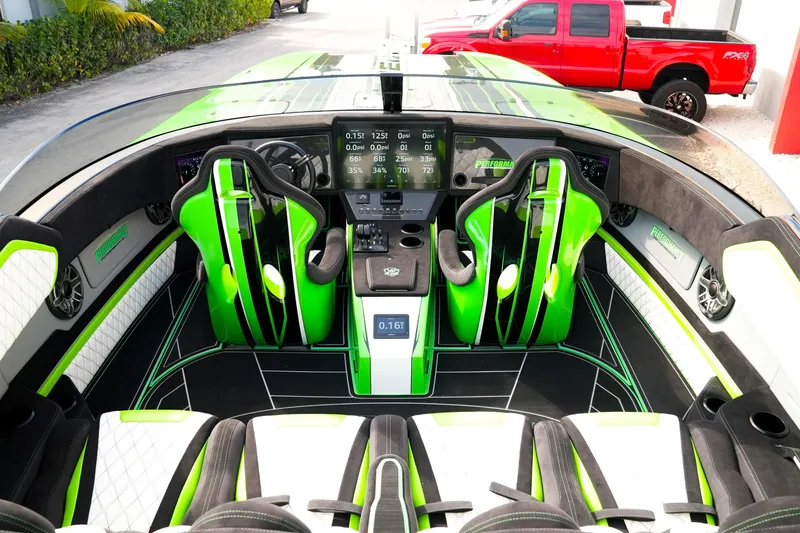 Slide: The Image of Interior of 2025 Performance Powerboats P360 with vibrant green accents and advanced dashboard. - 25