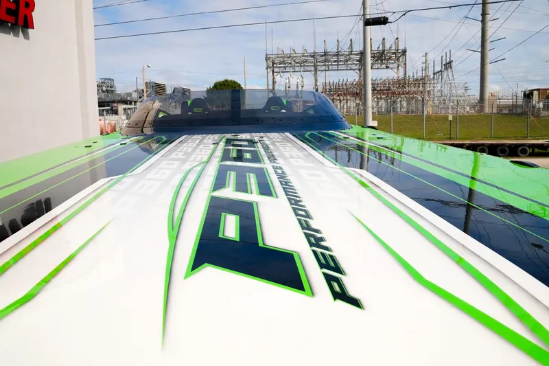 Slide: The Image of 2025 Performance Powerboats P360 with sleek green and white design, parked outdoors. - 29