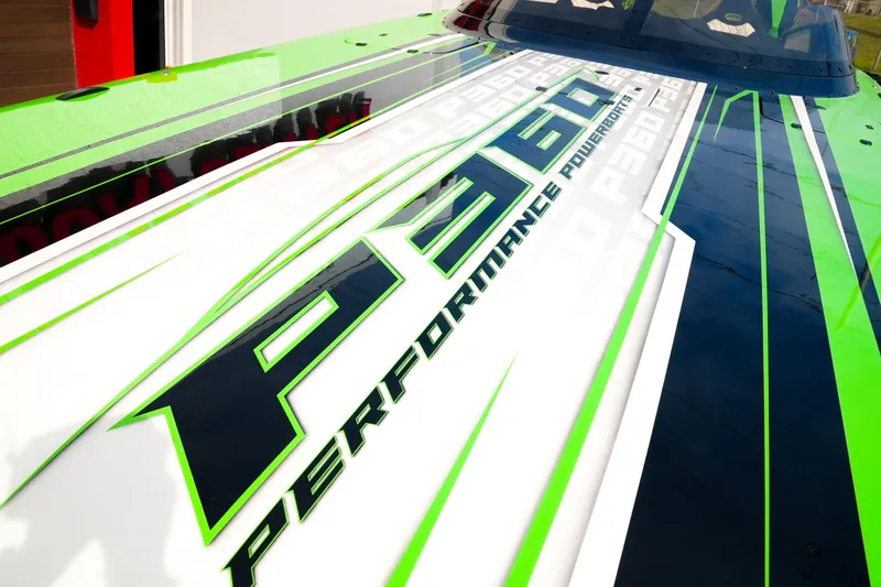 Slide: The Image of 2025 Performance Powerboats P360 with bold green and white graphics on deck. - 32