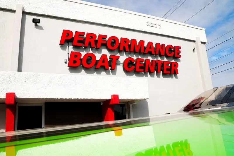 Slide: The Image of Performance Boat Center building exterior with bold red signage, showcasing Performance Powerboats P360, 2025 model. - 34