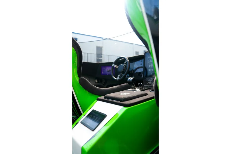 Slide: The Image of Interior of 2025 Performance Powerboats P360, featuring sleek green design and advanced controls. - 46