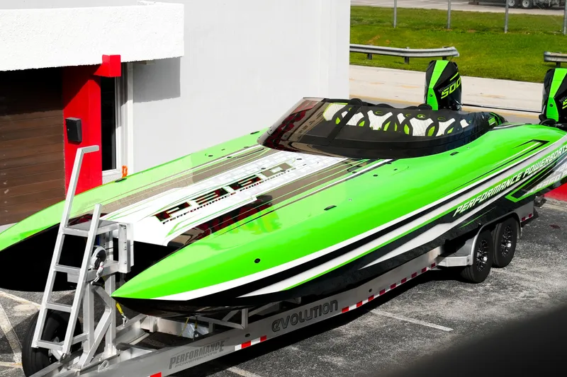 Slide: The Image of 2025 Performance Powerboats P360 in vibrant green on a trailer, showcasing sleek design. - 63