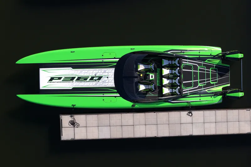 Slide: The Image of Aerial view of 2025 Performance Powerboat p360 docked, featuring vibrant green and black design. - 65