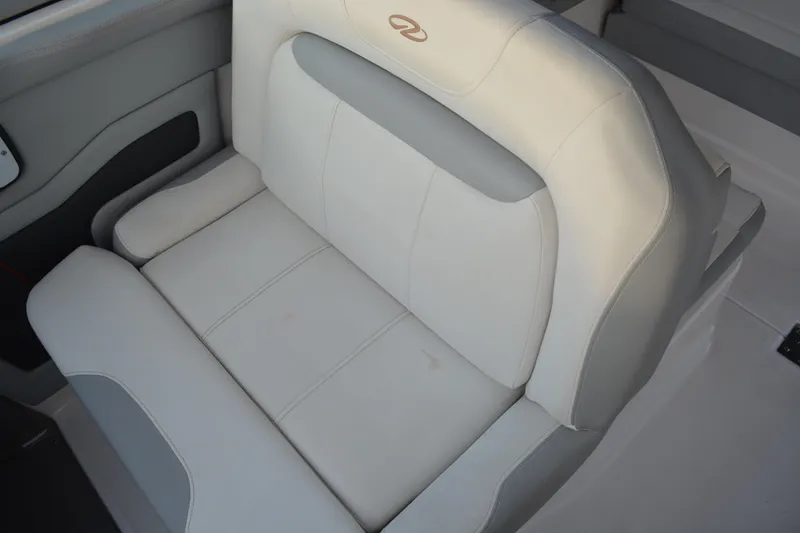Slide: The Image of 2016 Regal 28 Express boat seat, white and gray upholstery, interior view. - 10