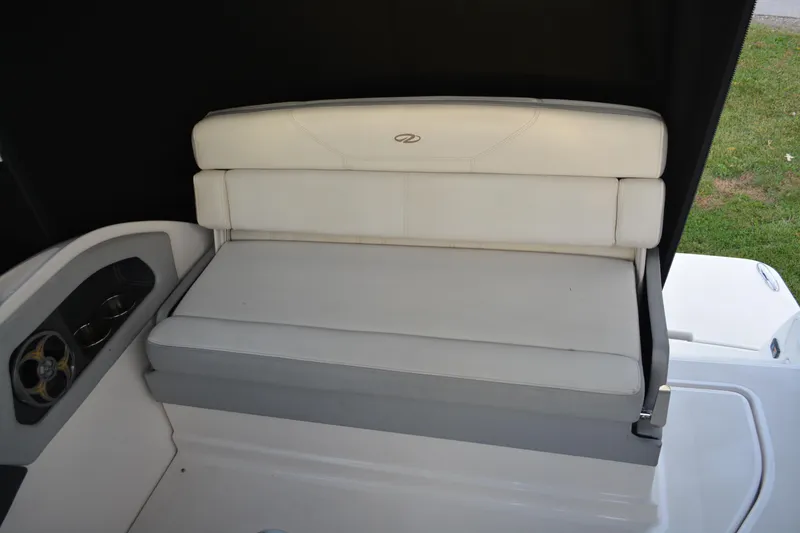 Slide: The Image of 2016 Regal 28 Express boat interior with white cushioned seating. - 13