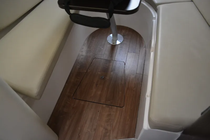 Slide: The Image of 2016 Regal 28 Express cabin interior with wood flooring and cushioned seating. - 19