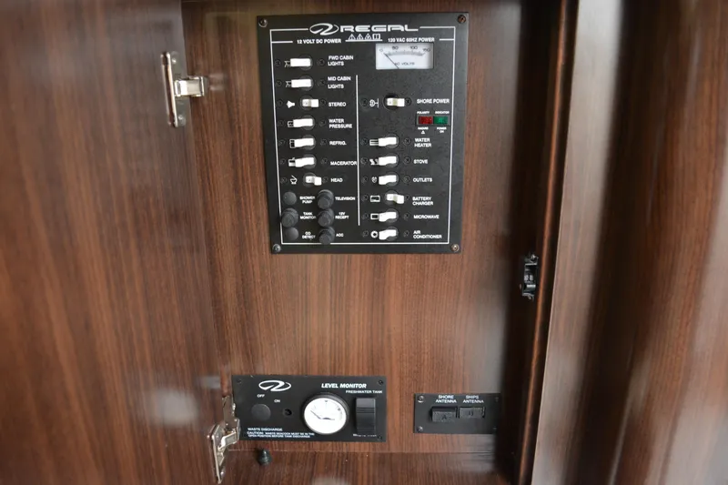 Slide: The Image of Control panel of a 2016 Regal 28 Express boat, featuring various switches and gauges. - 20