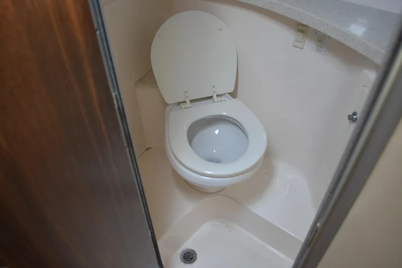 Slide: The Image of 2016 Regal 28 Express boat bathroom with toilet and countertop. - 29