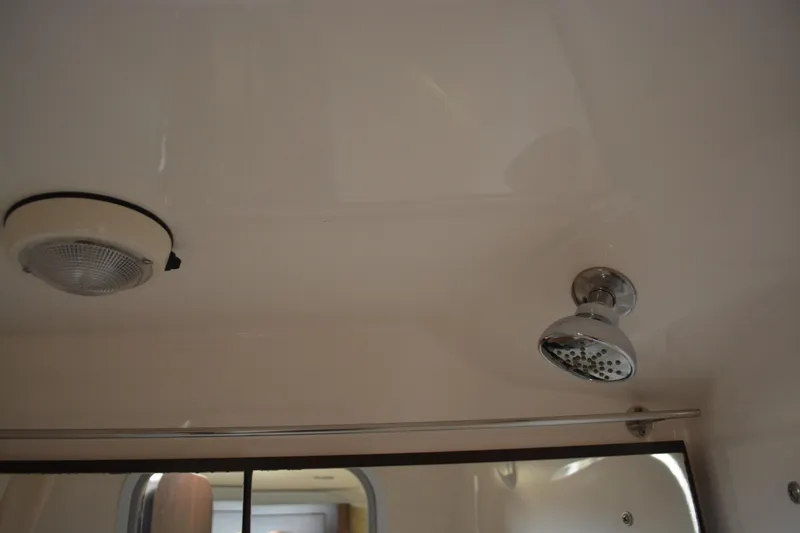 Slide: The Image of Ceiling view of 2016 Regal 28 Express boat interior with light and showerhead. - 31