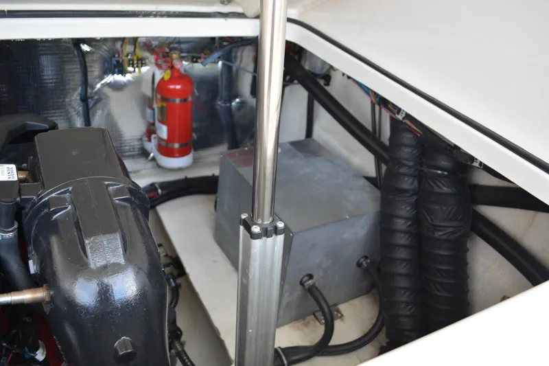 Slide: The Image of Engine compartment of 2016 Regal 28 Express boat with fire extinguisher and mechanical components. - 34