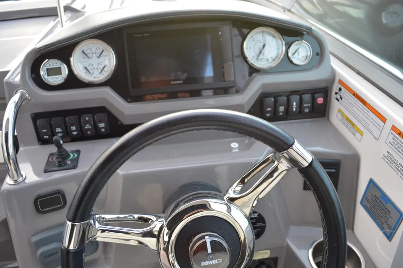 Slide: The Image of Dashboard of a 2016 Regal 28 Express boat with steering wheel and gauges. - 7