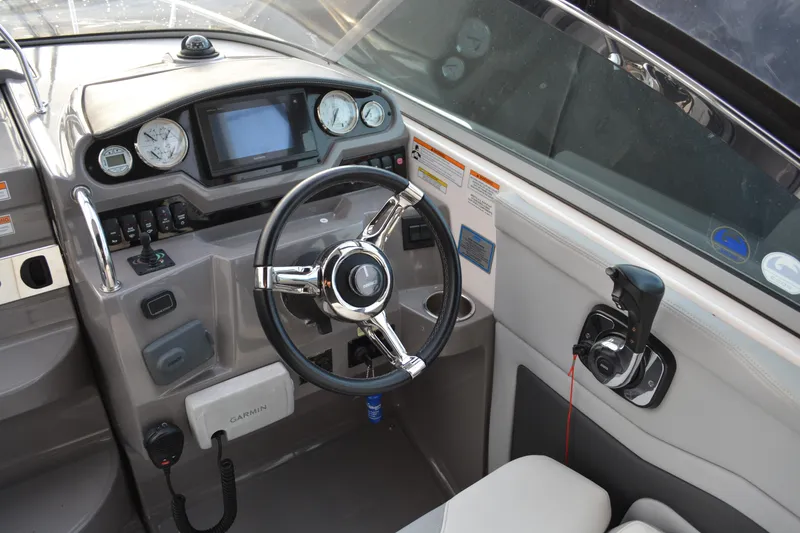 Slide: The Image of 2016 Regal 28 Express boat helm with steering wheel and control panel. - 8