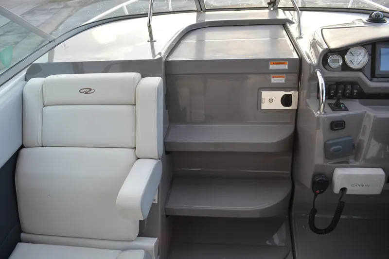 Slide: The Image of 2016 Regal 28 Express boat interior with helm, seating, and navigation equipment. - 9
