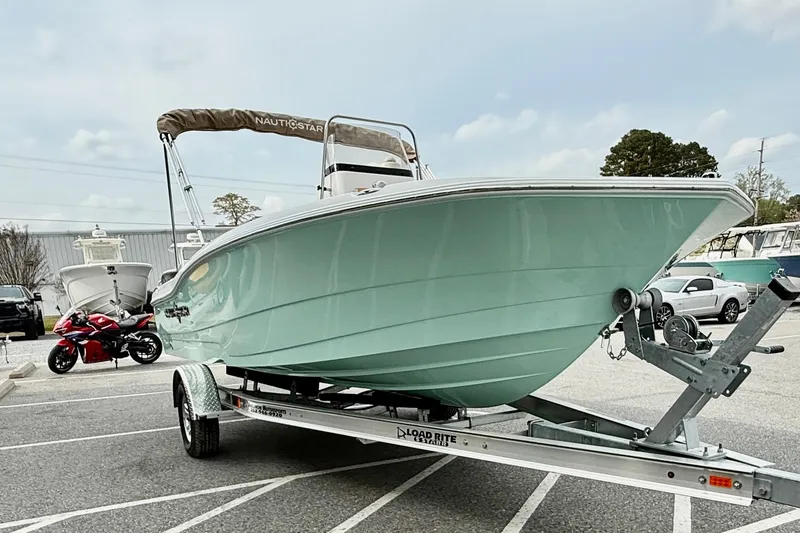 Slide: The Image of 2025 NauticStar 191 Hybrid boat on trailer in parking lot. - 10
