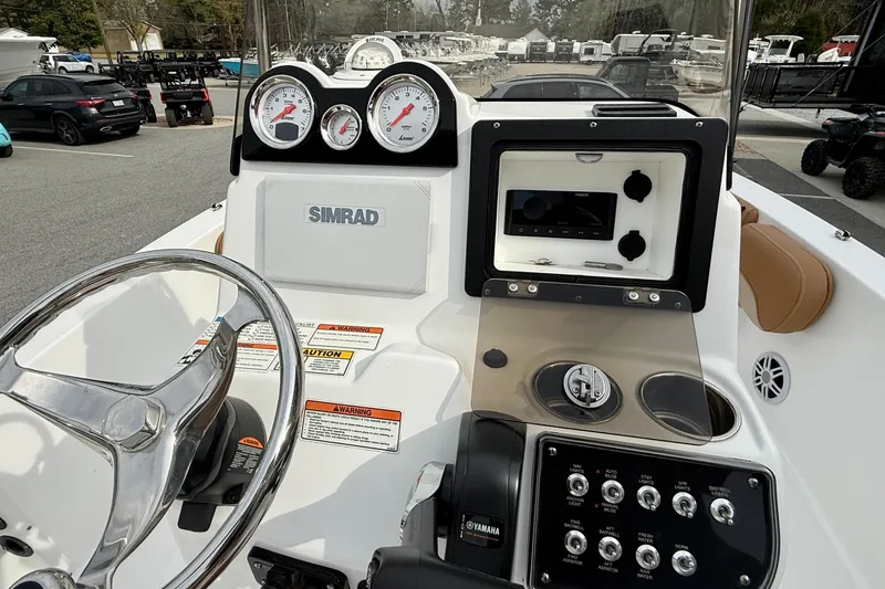 Slide: The Image of 2025 NauticStar 191 Hybrid boat dashboard with Simrad display and Yamaha controls. - 12