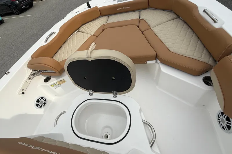 Slide: The Image of Interior of 2025 NauticStar 191 Hybrid boat with tan seating and storage compartment. - 15