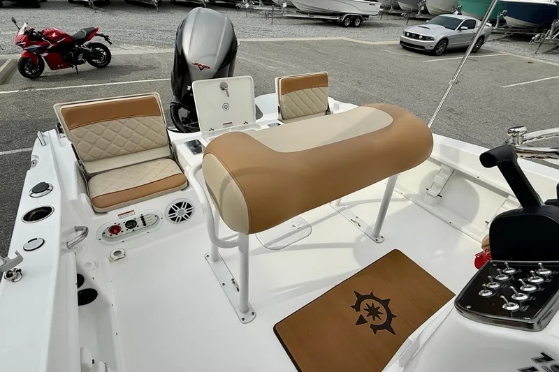 Slide: The Image of 2025 NauticStar 191 Hybrid boat interior with tan seating and control panel. - 17