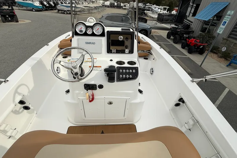Slide: The Image of 2025 NauticStar 191 Hybrid boat dashboard with steering wheel and controls. - 20
