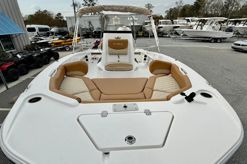 Slide: The Image of 2025 NauticStar 191 Hybrid boat with tan seating, displayed outdoors. - 22