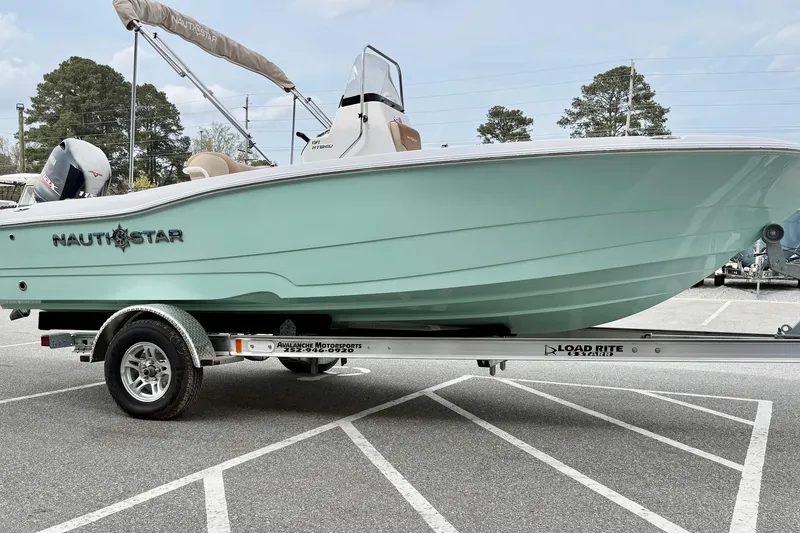 Slide: The Image of 2025 NauticStar 191 Hybrid boat on trailer in parking lot. - 6