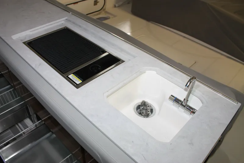 Slide: The Image of 2022 Tiara Yachts 43 LS yacht kitchen with sink and grill. - 10