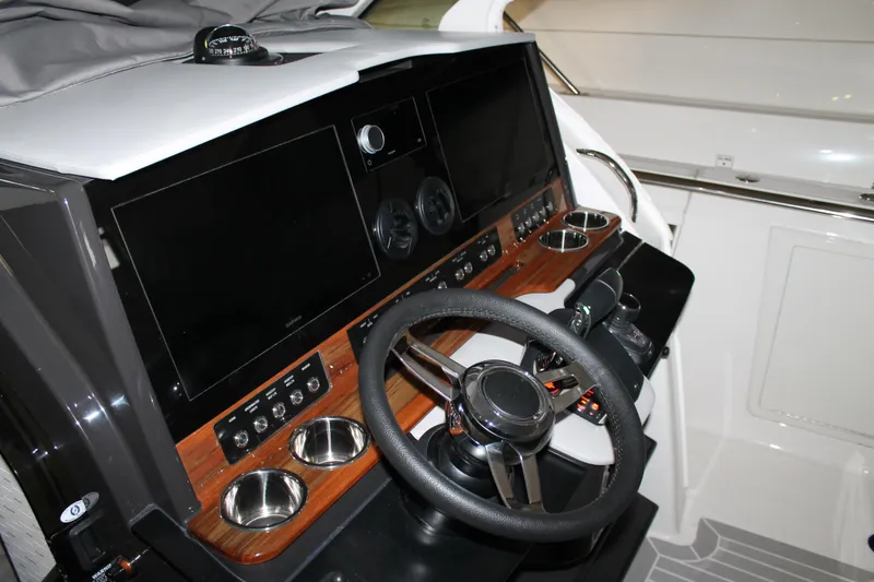 Slide: The Image of 2022 Tiara Yachts 43 LS helm with modern controls and navigation displays. - 11