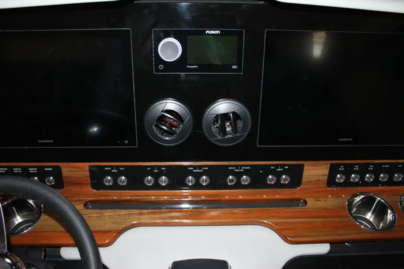 Slide: The Image of Dashboard of 2022 Tiara Yachts 43 LS with Garmin displays and Fusion audio system. - 13