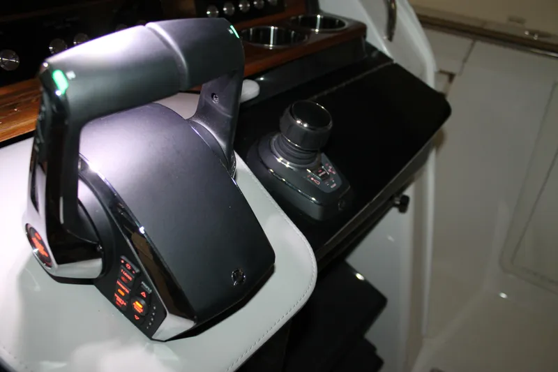 Slide: The Image of Control panel of 2022 Tiara Yachts 43 LS, featuring modern throttle and joystick. - 16