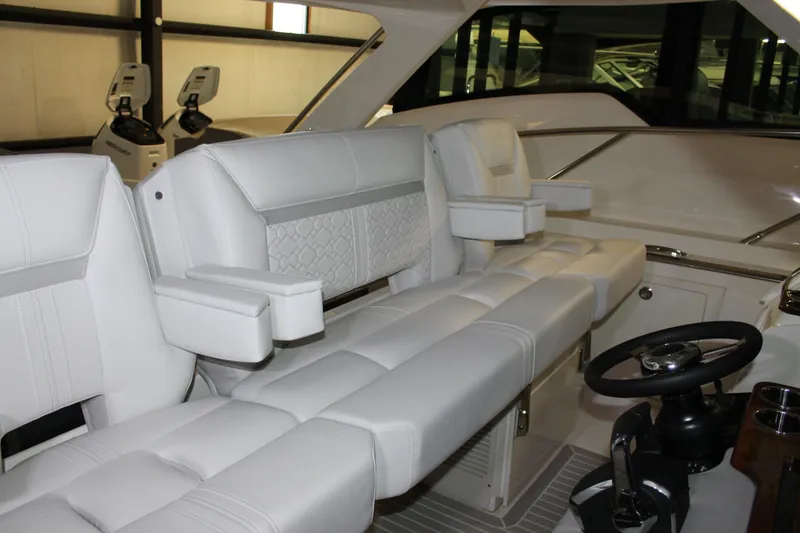Slide: The Image of Luxurious interior seating of 2022 Tiara Yachts 43 LS with modern helm controls. - 18