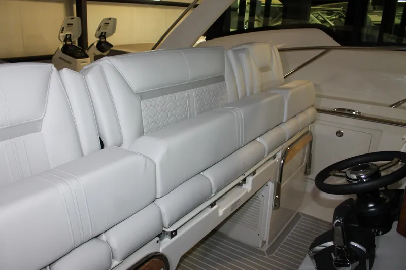 Slide: The Image of 2022 Tiara Yachts 43 LS interior with luxurious seating and modern helm controls. - 19