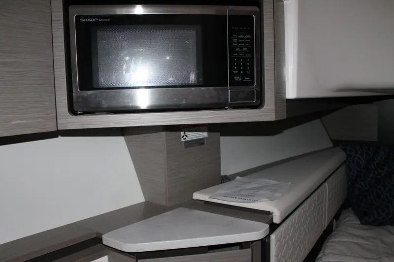 Slide: The Image of Interior of 2022 Tiara Yachts 43 LS featuring a built-in microwave. - 32