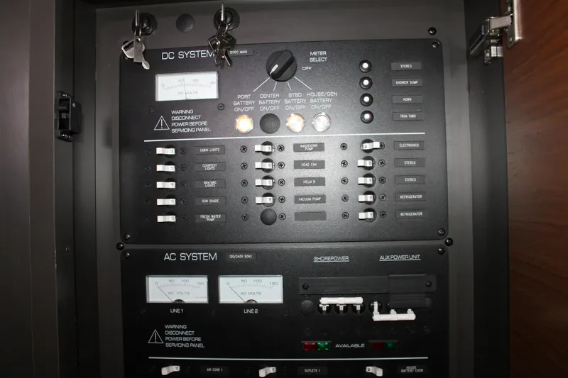 Slide: The Image of Electrical control panel on a 2022 Tiara Yachts 43 LS, featuring DC and AC systems. - 35