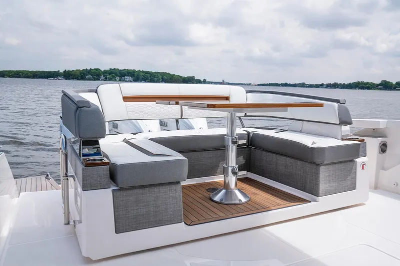 Slide: The Image of Manufacturer Provided Image: 2022 Tiara Yachts 43 LS luxury seating area with table on a serene lake. - 43