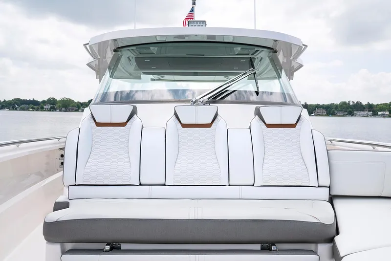 Slide: The Image of Manufacturer Provided Image: 2022 Tiara Yachts 43 LS boat with luxurious white seating and scenic water backdrop. - 45