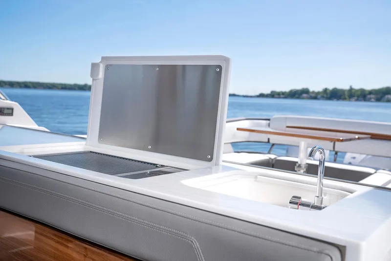 Slide: The Image of Manufacturer Provided Image: Outdoor kitchen area on 2022 Tiara Yachts 43 LS, featuring a sink and grill. - 50