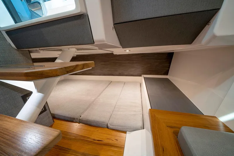 Slide: The Image of Manufacturer Provided Image: 2022 Tiara Yachts 43 LS interior cabin with wooden flooring and cushioned seating. - 54
