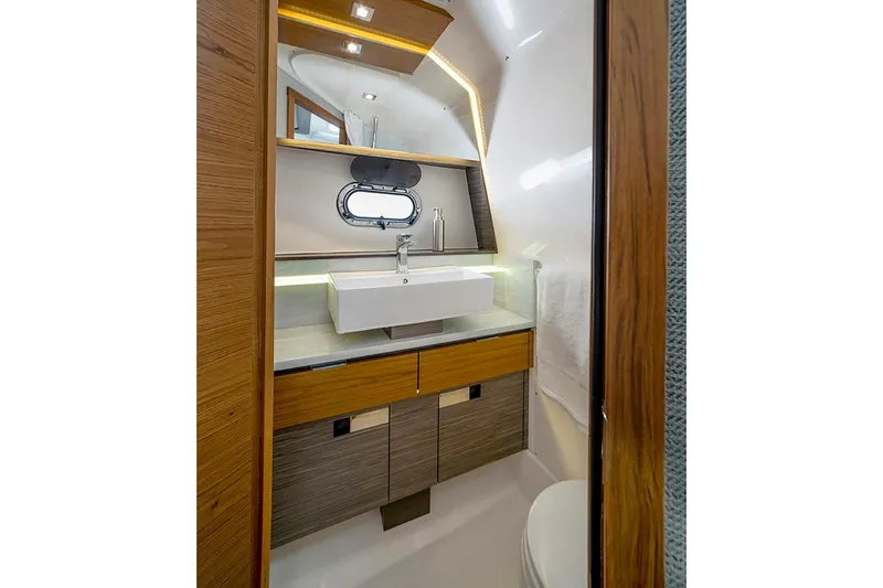 Slide: The Image of Manufacturer Provided Image: 2022 Tiara Yachts 43 LS bathroom with modern sink and wooden cabinetry. - 55