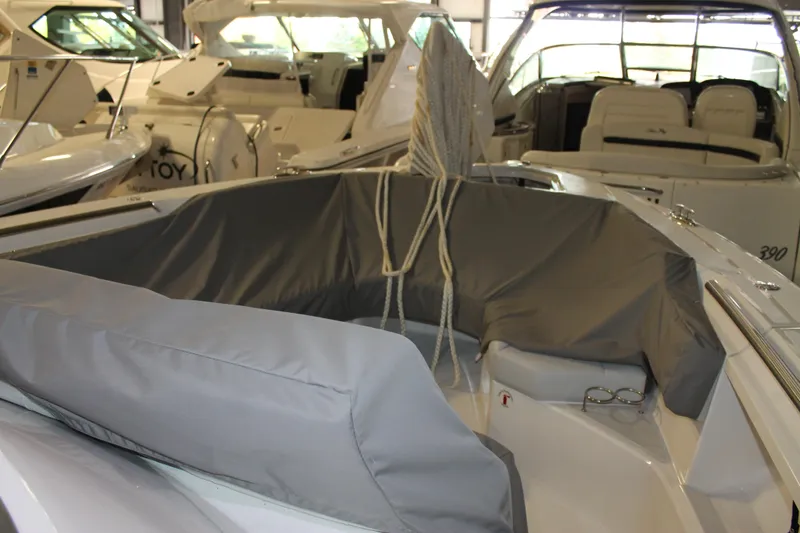 Slide: The Image of 2022 Tiara Yachts 43 LS interior with covered seating in a showroom. - 59