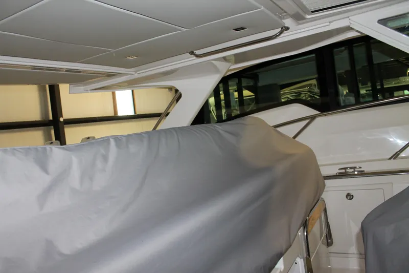 Slide: The Image of 2022 Tiara Yachts 43 LS interior with covered seating and modern design. - 60