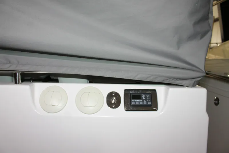 Slide: The Image of 2022 Tiara Yachts 43 LS control panel with Dometic display and covered equipment. - 62