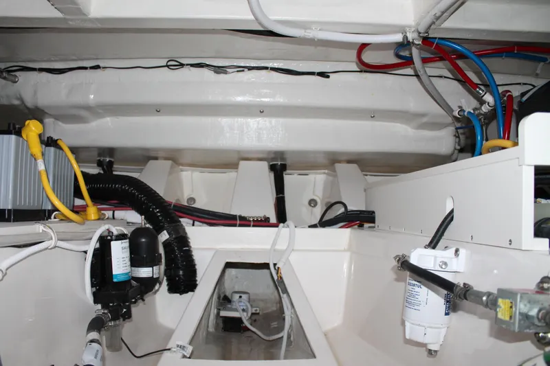 Slide: The Image of Engine compartment of 2022 Tiara Yachts 43 LS, showcasing wiring and components. - 68