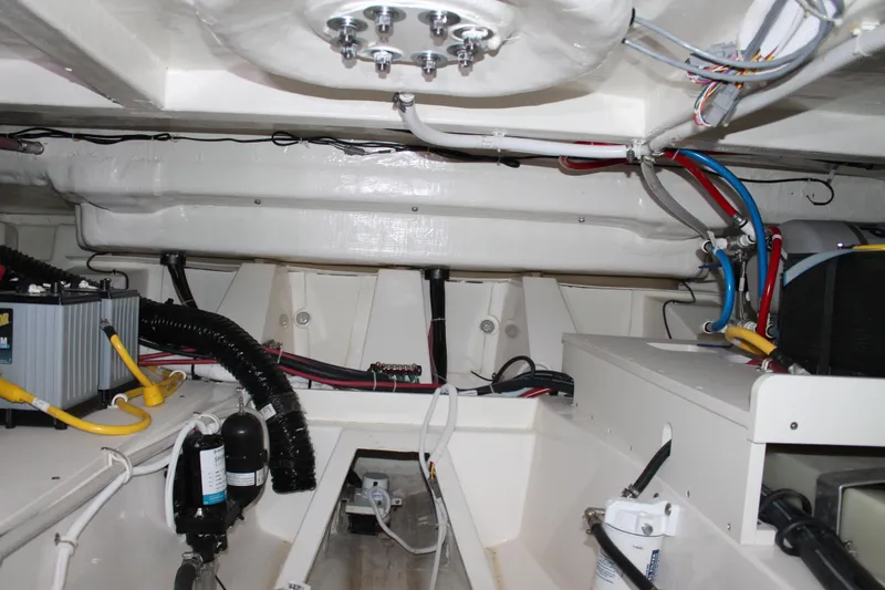 Slide: The Image of Engine room of 2022 Tiara Yachts 43 LS, showcasing wiring and mechanical components. - 69