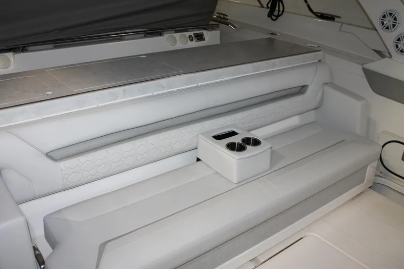 Slide: The Image of 2022 Tiara Yachts 43 LS interior seating with cup holders and modern design. - 7