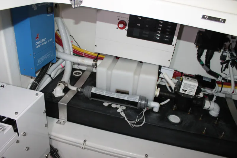 Slide: The Image of Engine compartment of 2022 Tiara Yachts 43 LS, featuring battery charger and wiring. - 72